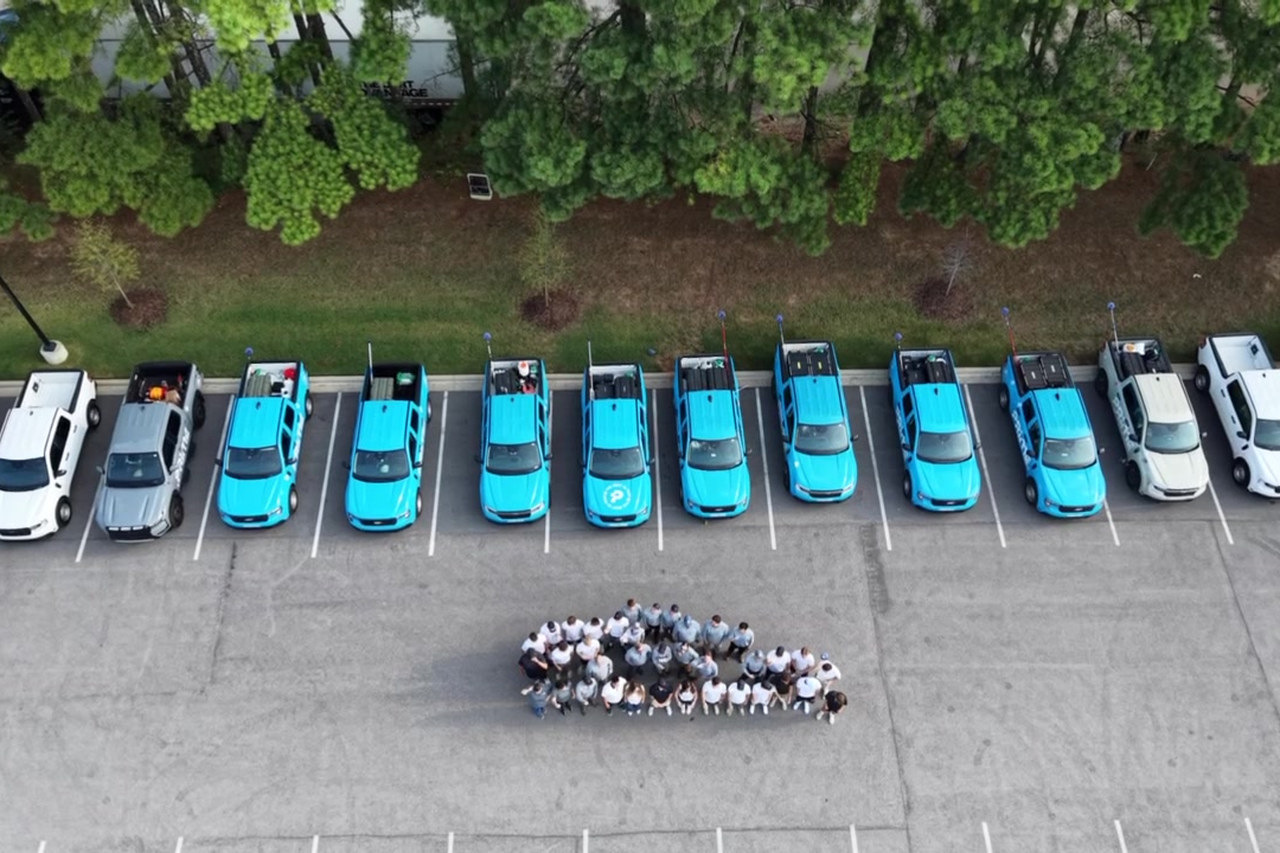Aerial view of the Prime Pest Control fleet and team